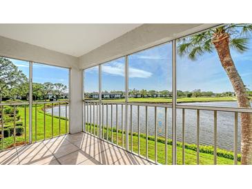 Spacious screened balcony overlooking a serene lake and golf course at 5218 Wedgewood Ln # 72, Sarasota, FL 34235