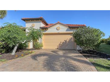 House exterior featuring a two-car garage and manicured landscaping at 10656 Glencorse Ter, Bradenton, FL 34211
