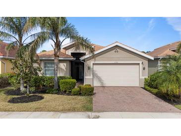 Single-story home with a two-car garage and manicured landscaping at 11550 Blackfin St, Venice, FL 34292