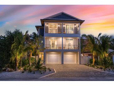 Stunning two-story home with a two-car garage and beautifully landscaped front yard at 150 Grant Dr, Sarasota, FL 34236