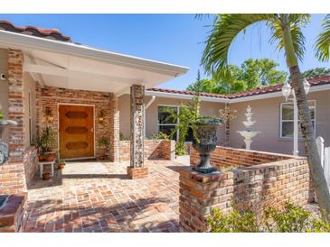 Inviting front entrance with brick detailing and a charming courtyard at 2605 Desoto Rd, Sarasota, FL 34234