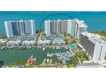 Aerial view of waterfront condo building with marina and pool at 988 Blvd Of The Arts # 311, Sarasota, FL 34236