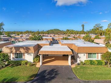 Aerial view of a community of villas with lush landscaping at 2505 Riverbluff Pkwy # V196, Sarasota, FL 34231