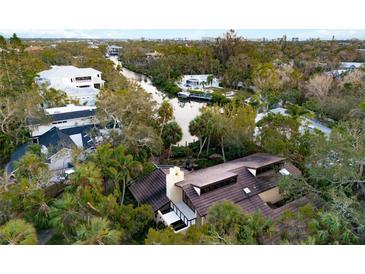 Aerial view of waterfront home with private dock and lush landscaping at 5112 Jungle Plum Rd, Sarasota, FL 34242