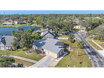 Aerial view of a single-Gathering home with a lake and lush landscaping at 5384 Sarapointe Ct, Sarasota, FL 34232