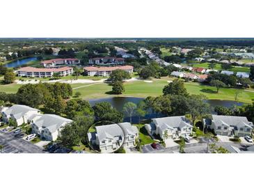 Aerial view of a community with golf course and lake at 5507 Fair Oaks St # 3-C, Bradenton, FL 34203