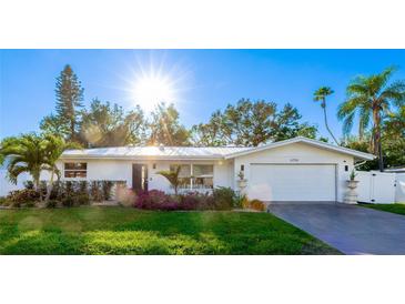 White single-story home with landscaped lawn and attached garage at 6726 S Lockwood Ridge Rd, Sarasota, FL 34231
