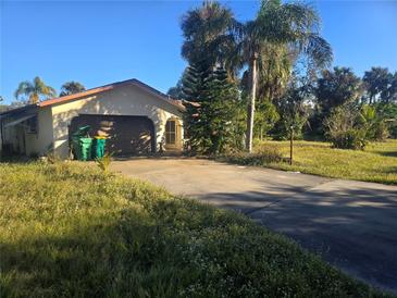 Ranch-style home with attached garage and spacious yard at 1346 Kenmore St, Port Charlotte, FL 33952
