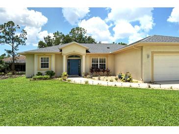 Single-story home with a landscaped lawn and attached garage at 1447 Allegheny Ln, North Port, FL 34286