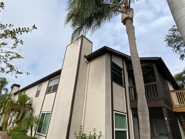 Tan building exterior with dark brown accents, balcony, and palm tree at 3750 59Th W Ave # 4096, Bradenton, FL 34210