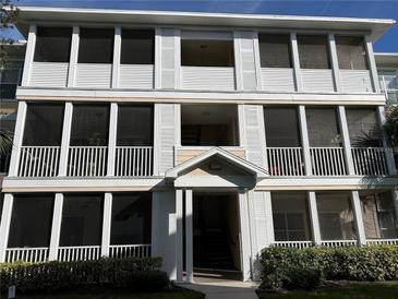 Three-story building exterior with screened balconies and landscaping at 4802 51St W St # 708, Bradenton, FL 34210
