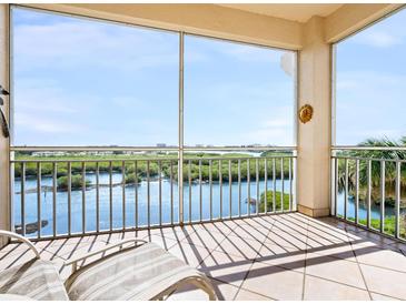 Spacious screened balcony overlooking water and lush landscape at 5440 Eagles Point Cir # 405, Sarasota, FL 34231