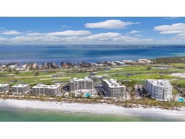 Aerial view of luxury beachfront condos with ocean and golf course views at 545 Sanctuary Dr # A803, Longboat Key, FL 34228