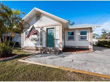 Charming bungalow with a newly painted exterior, fresh landscaping, and a teal front door at 1302 18Th W St, Bradenton, FL 34205