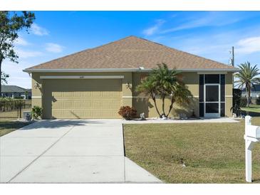 Charming single-story home with a two-car garage and landscaped yard at 16499 Becasse Dr, Punta Gorda, FL 33955