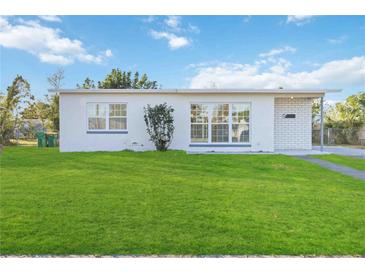 Newly renovated home with a modern facade and lush lawn at 21907 Cellini Ave, Port Charlotte, FL 33952