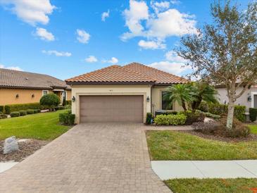 Single-story home with a 2-car garage and landscaped front yard at 4611 Alexandria Ct, Palmetto, FL 34221