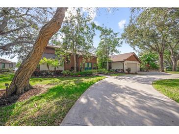 Inviting home exterior, featuring a circular driveway and lush landscaping at 5020 Willow Leaf Way, Sarasota, FL 34241