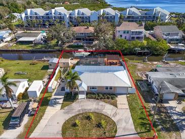 Aerial view of a single-story home with private boat dock and canal access at 524 Palm Ave, Ellenton, FL 34222