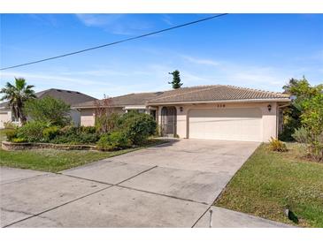 Single-story home with attached garage and landscaped front yard at 339 Rio De Janeiro Ave, Punta Gorda, FL 33983
