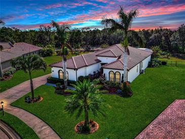 Single-story home with tile roof, landscaping, and pool at 348 165Th Ne Ct, Bradenton, FL 34212