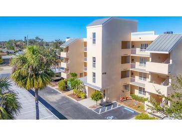 Exterior view of a three-story condo building with parking and landscaping at 4110 Ironwood Cir # 301, Bradenton, FL 34209