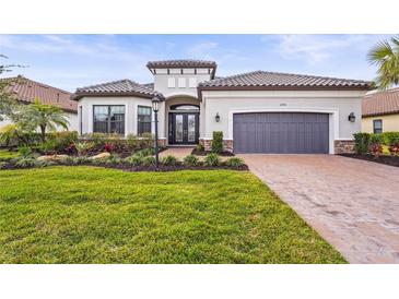 Single-story home with gray garage door and landscaped yard at 4534 Trento Pl, Bradenton, FL 34211