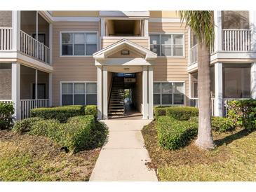Inviting condo building entrance with landscaping and stairs at 4802 51St W St # 1304, Bradenton, FL 34210