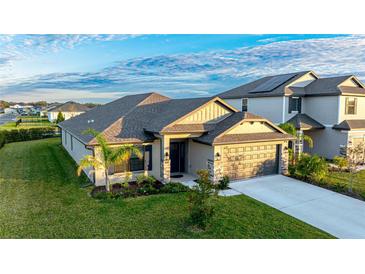 One-story home with a two-car garage, landscaping, and a neutral color palette at 6138 162Nd E Ave, Parrish, FL 34219