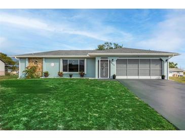 Charming ranch home with a newly paved driveway and well-manicured lawn at 625 Ennis Nw Ter, Port Charlotte, FL 33952