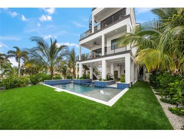 Luxury home with private pool, expansive patio, and lush landscaping at 116 8Th Street S, Bradenton Beach, FL 34217