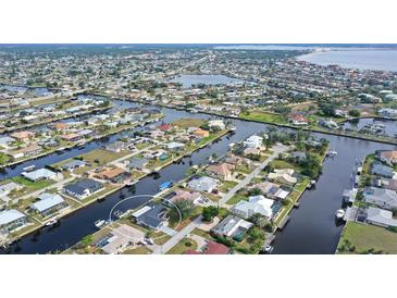 Aerial view of waterfront home community, showcasing canals and houses at 128 Sinclair Se St, Port Charlotte, FL 33952