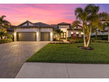 Stunning curb appeal with lush landscaping and a two-car garage at 16203 Tradewind Ter, Bradenton, FL 34211