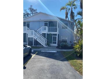 Light blue two-story building with white stairs and screened balconies at 3743 59Th W Ave # 3743, Bradenton, FL 34210