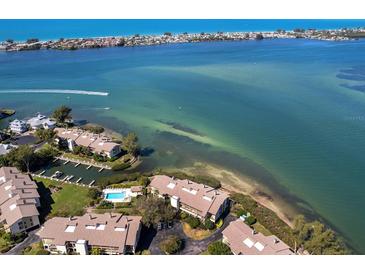 Aerial view of waterfront community with resort-style pool and boat slips at 3860 Mariners Way # 413, Cortez, FL 34215