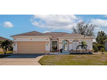 Single-story home with attached garage, landscaping, and a well-maintained lawn at 4111 Hemingway Dr, Venice, FL 34293