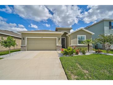 One-story home with a two-car garage and landscaped front yard at 5282 Grove Mill Loop, Bradenton, FL 34211