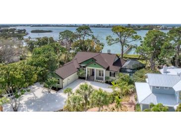 Luxury waterfront home with private dock and lush landscaping at 603 Harbor Shore Dr, Nokomis, FL 34275