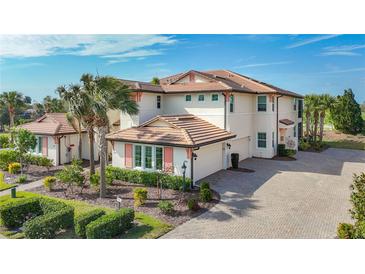 Luxury two-story home with tile roof, and landscaped grounds at 7486 Divot Loop # 7486, Bradenton, FL 34202