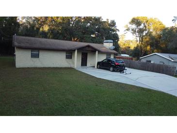 Single story home with a carport and spacious yard at 219 E Early St, Brooksville, FL 34601