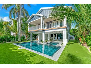 Two-story home with a pool and lush landscaping at 2208 Avenue A, Bradenton Beach, FL 34217