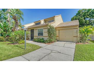 Tan two-story home with attached garage and lush landscaping at 3429 57Th Avenue W Dr # 15, Bradenton, FL 34210