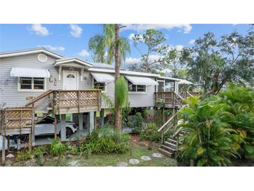 Elevated home with wrap-around deck, offering ample outdoor space at 39200 Cook Brown Rd, Punta Gorda, FL 33982
