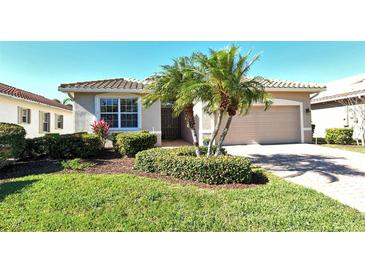 Single-story home with a two-car garage and landscaped front yard at 6422 42Nd E St, Sarasota, FL 34243