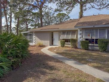 Tan house exterior with walkway, landscaping, and screened porch at 727 N Jefferson Ave # 727, Sarasota, FL 34237