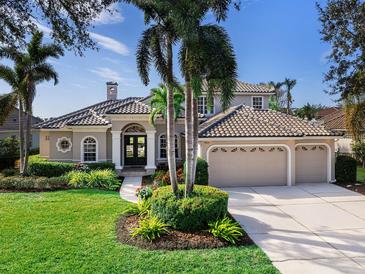 Beautiful two-story home with tile roof, landscaping, and three-car garage at 9420 Old Hyde Park Pl, Lakewood Ranch, FL 34202