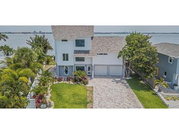 Two-story waterfront home with modern design and large yard at 970 Boca Ciega Isle Dr, St Pete Beach, FL 33706