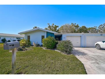 Single story home with attached two-car garage and well-maintained lawn at 1312 Stafford Ln # 1427, Sarasota, FL 34232