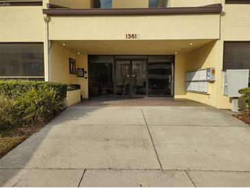 Condo building entrance with mailboxes and landscaping at 13612 South Village Dr # 105, Tampa, FL 33618