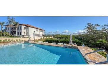 Inviting pool area with expansive patio and gorgeous water views at 3858 Casey Key, Nokomis, FL 34275